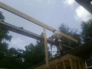 Carpenter setting a ridge beam over a new addition frame — Ice Dam Removal by Roofing Brothers in West Yellowstone
